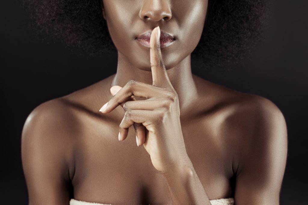 Woman and silence gesture