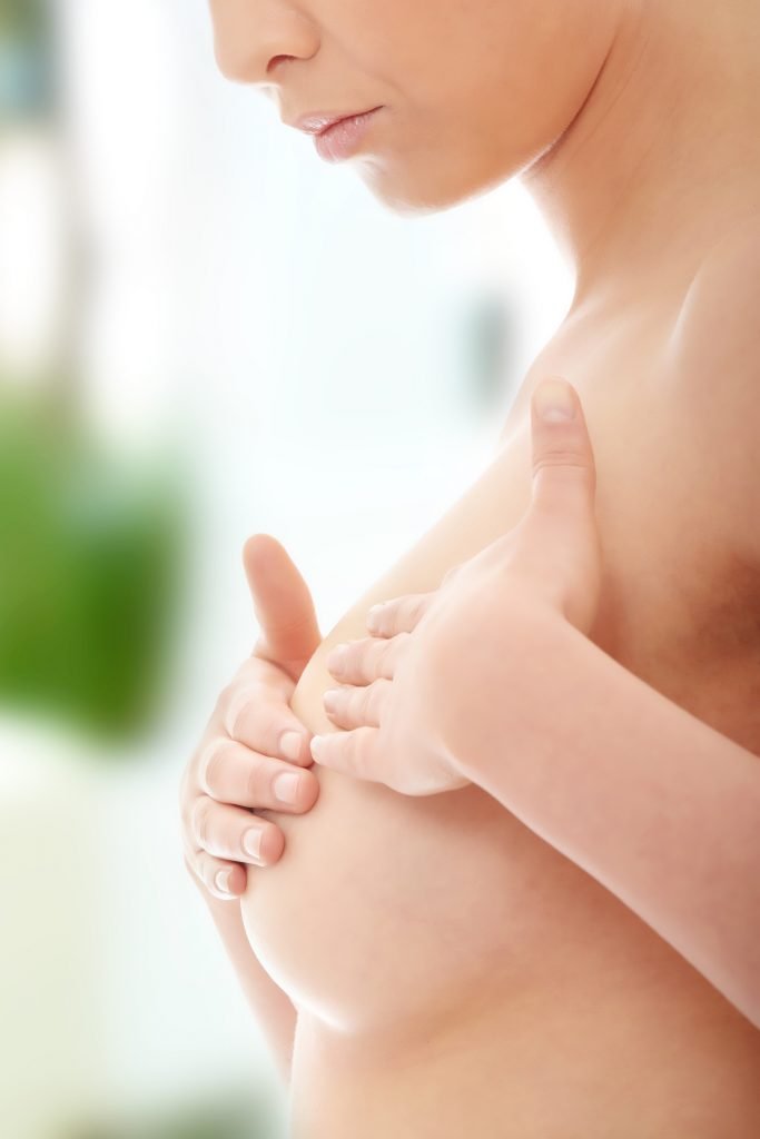 Woman checking her breast